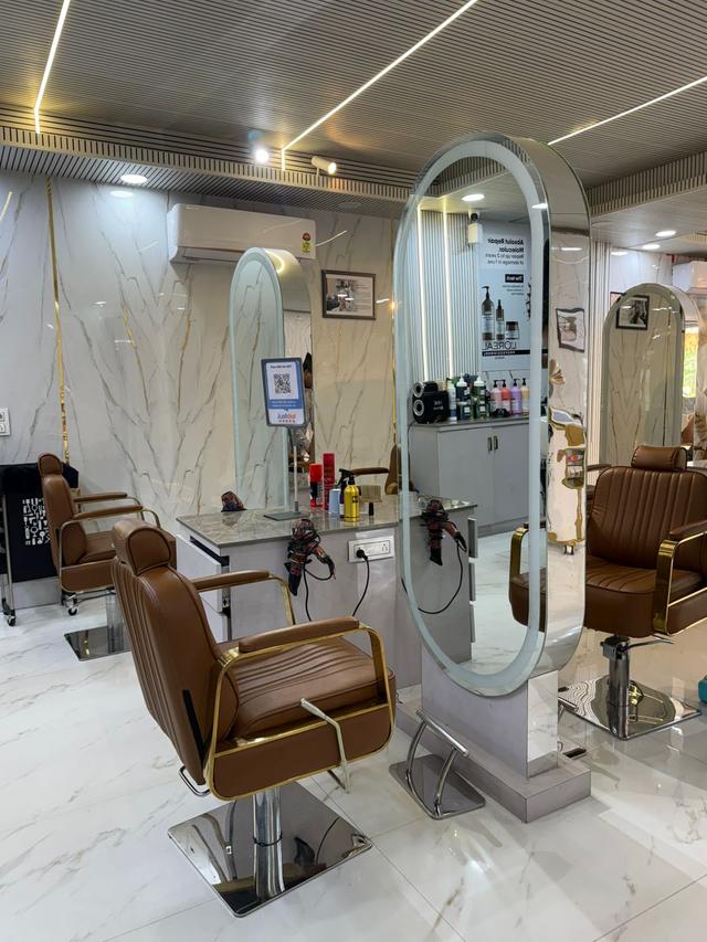 Unisex hair studio with LED mirrors, professional styling tools and L'Oréal Professionnel products.